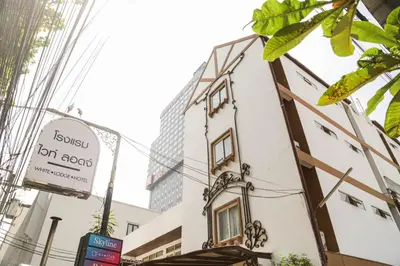 a building with a sign on the side of it at White Lodge Hotel Bangkok in Bangkok