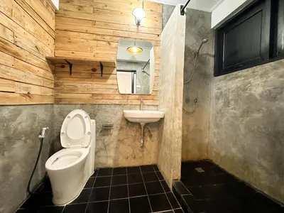 a bathroom with a toilet and a sink at White Lodge Hotel Bangkok in Bangkok
