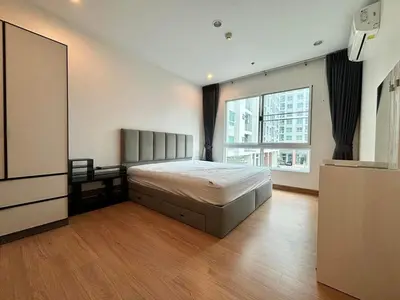 a bedroom with a bed and a large window at Supalai Wellington 2 Near MRT in Bangkok