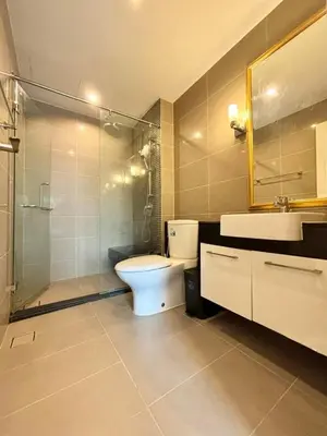 a bathroom with a toilet and a sink and a shower at Supalai Wellington 2 Near MRT in Bangkok