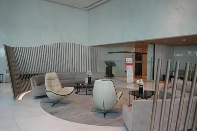 a lobby with couches and tables and a piano at Luxury room close to BTS in Bangkok