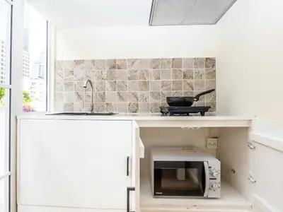 a kitchen with a counter with a microwave in it at 2 Bedroom for 3 guests in heart Sathorn with Balcony in Bangkok