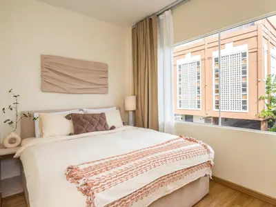 a bedroom with a large bed and a window at 2 Bedroom for 3 guests in heart Sathorn with Balcony in Bangkok