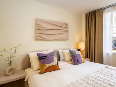 a bedroom with a bed with pillows on it at 2 Bedroom for 4 guests Private in center of Sathorn in Bangkok