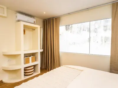 a bedroom with a bed and a large window at 2 Bedroom for 4 guests Private in center of Sathorn in Bangkok