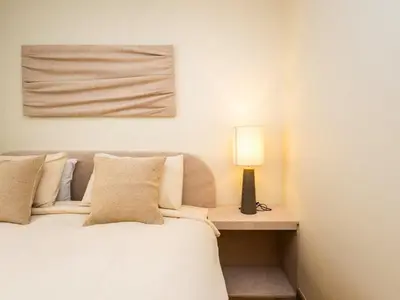 a bedroom with a bed and a lamp on a table at 2 Bedroom for 4 guests Private in center of Sathorn in Bangkok