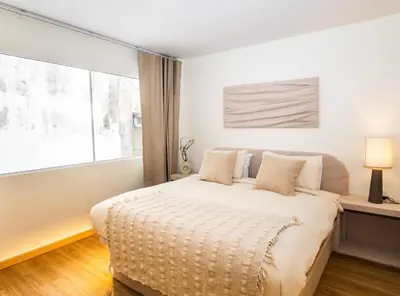 a bedroom with a bed with a large window at 2 Bedroom for 4 guests Private in center of Sathorn in Bangkok