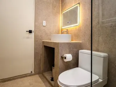 a bathroom with a white toilet and a sink at 2 Bedroom for 4 guests Private in center of Sathorn in Bangkok