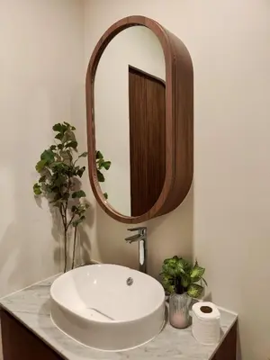 a bathroom with a white sink and a mirror at Chobjai Hostelry - Chaw Cher Home at Bang Kra Jao in Bang Krasop