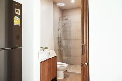 a bathroom with a toilet and a shower at Chobjai Hostelry - Chaw Cher Home at Bang Kra Jao in Bang Krasop