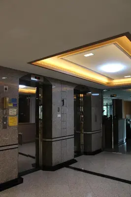 a lobby with a row of elevators in a building at Bangkok Place Apartment - EKAMAI BTS in Bangkok