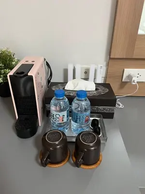 a kitchen with two bottles of water and a printer at Bangkok Place Apartment - EKAMAI BTS in Bangkok