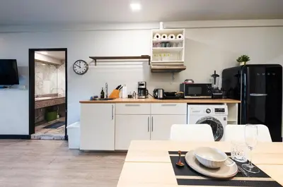 a kitchen with white appliances and a table with chairs at NEW Bangkok centre-2 bedrooms Netflix 31 floor in Bangkok