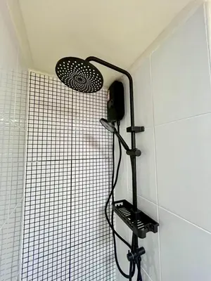 a shower with a shower head in a bathroom at Happy House T8 in Thung Si Kan