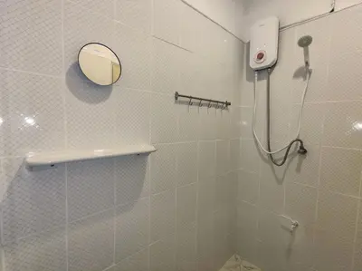 a bathroom with a shower with a mirror at Lumphini 3 Teakwood red at Steamy Location in Bangkok