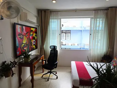 a bedroom with a desk and a bed and a window at Lumphini 7 Townhouse Master Authentic BKK Comfort in Bangkok