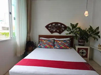 a bedroom with a bed with a red and white blanket at Lumphini 7 Townhouse Master Authentic BKK Comfort in Bangkok