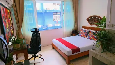 a bedroom with a bed and a window and a chair at Lumphini 7 Townhouse Master Authentic BKK Comfort in Bangkok