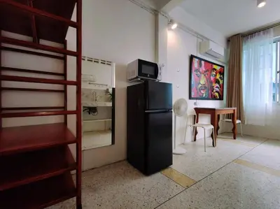 a room with a refrigerator and a dining room with a table at Lumphini 7 Townhouse Master Authentic BKK Comfort in Bangkok