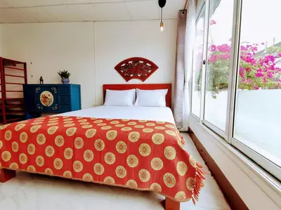 a bedroom with a bed and a large window at Lumphini Perfect Escape Sunny Rooftop EnSuite in Bangkok