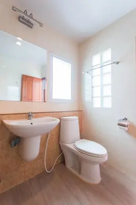 a bathroom with a sink and a toilet and a mirror at Cloud no 5 Generous space Green n Quiet Heart BKK in Bangkok