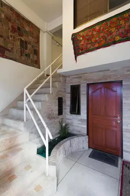 a staircase with a wooden door in a building at Cloud no 5 Generous space Green n Quiet Heart BKK in Bangkok
