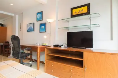 a bedroom with a desk with a television and a deskicterictericterictericter at Cloud no 5 Generous space Green n Quiet Heart BKK in Bangkok