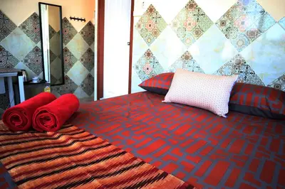a bed with two red pillows on top of it at SKY 10 Convenient near Lumphini Park and MRT in Bangkok