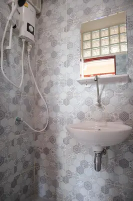 a bathroom with a shower and a sink at SKY 10 Convenient near Lumphini Park and MRT in Bangkok