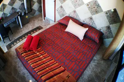 a bedroom with a bed with red and white pillows at SKY 10 Convenient near Lumphini Park and MRT in Bangkok