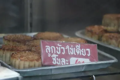 a tray of muffins with a sign in front of them at SKY 14 Vibrant street Cozy n Cool near center in Bangkok