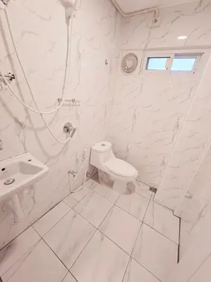 a white bathroom with a toilet and a sink at Crane nest 1 Easy-peasy no stairs in Bangkok