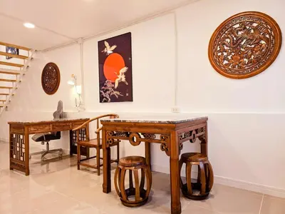 a room with wooden tables and plates on the wall at Crane nest 14 loft with views over Sathorn in Bangkok