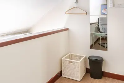 a staircase with a trash can in a room at Nueng Rana 232 Corner view 1BR Duplex 3beds / 2B in Samphanthawong