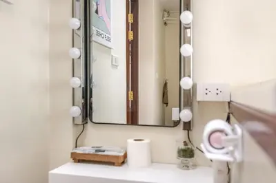 a bathroom with a mirror and a sink at Nueng Rana 232 Corner view 1BR Duplex 3beds / 2B in Samphanthawong