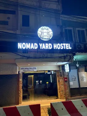 a sign for a nomad yard hostel on a building at Nomad Yard Hostel in Bangkok