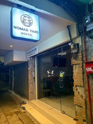 a sign for a nordyard yard hostel in a building at Nomad Yard Hostel in Bangkok