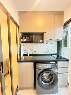 a kitchen with a washing machine and a sink at The CLEV Riverline Chaophraya in Nonthaburi
