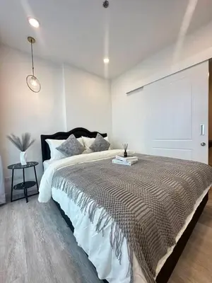 a bedroom with a large bed in a room at The CLEV Riverline Chaophraya in Nonthaburi
