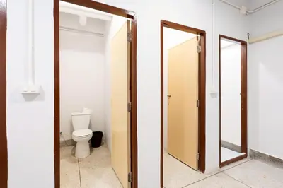 a bathroom with a toilet and a mirror at XX Mitr Inn Khaosan Street - มิตร อินน์ ตรอกข้าวสาร in Bangkok