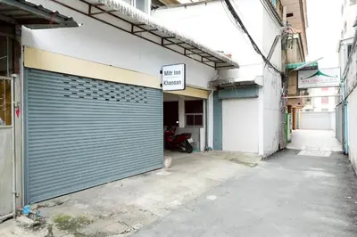 a garage door on the side of a building at XX Mitr Inn Khaosan Street - มิตร อินน์ ตรอกข้าวสาร in Bangkok