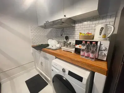 a small kitchen with a counter and a dishwasher at Lazy Nest at Impact Muangthong in Thung Si Kan
