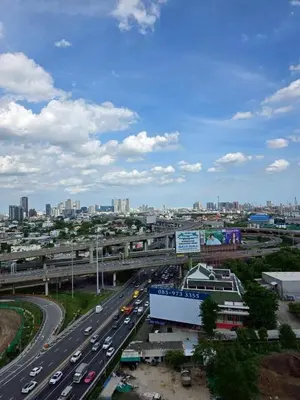 a highway with cars on it with a city in the background at Modiz Modiza Sukhumvit R1 in Bangkok