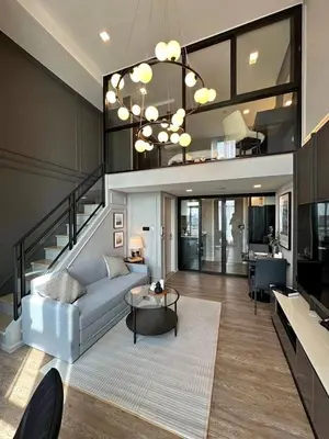 a living room with a couch and a table at Modiz Modiza Sukhumvit R2 in Bangkok
