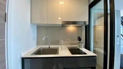 a kitchen with a sink and a counter top at Modiz Modiza Sukhumvit R4 in Bangkok