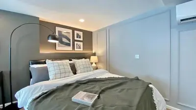 a bedroom with a bed with a book on it at Modiz Modiza Sukhumvit R4 in Bangkok