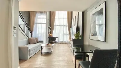 a living room with a couch and a table at Modiz Modiza Sukhumvit R4 in Bangkok