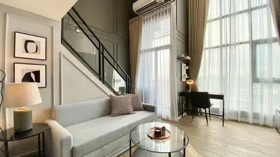 a living room with a couch and a table at Modiz Modiza Sukhumvit R4 in Bangkok