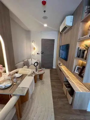 a living room with a couch and a table at Modiz Modiza Sukhumvit R5 in Bangkok