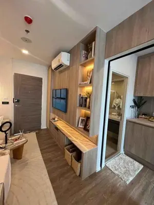 a living room with a couch and a television at Modiz Modiza Sukhumvit R5 in Bangkok